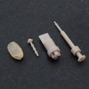 Here are some examples of PEEK micro-processed parts compared to the size of Genmai's rice grain